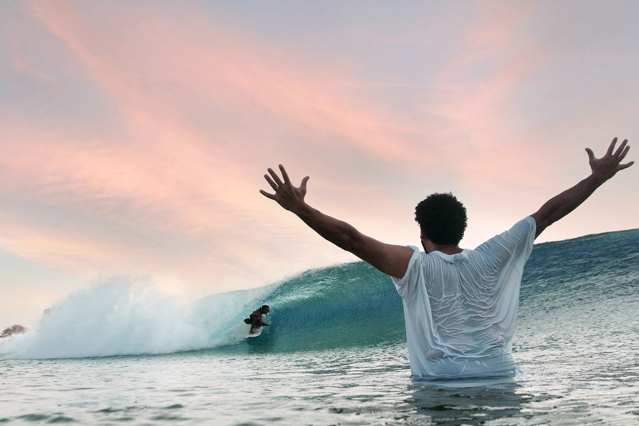 Surf guide helping a young surfer at Surf Abu Dhabi